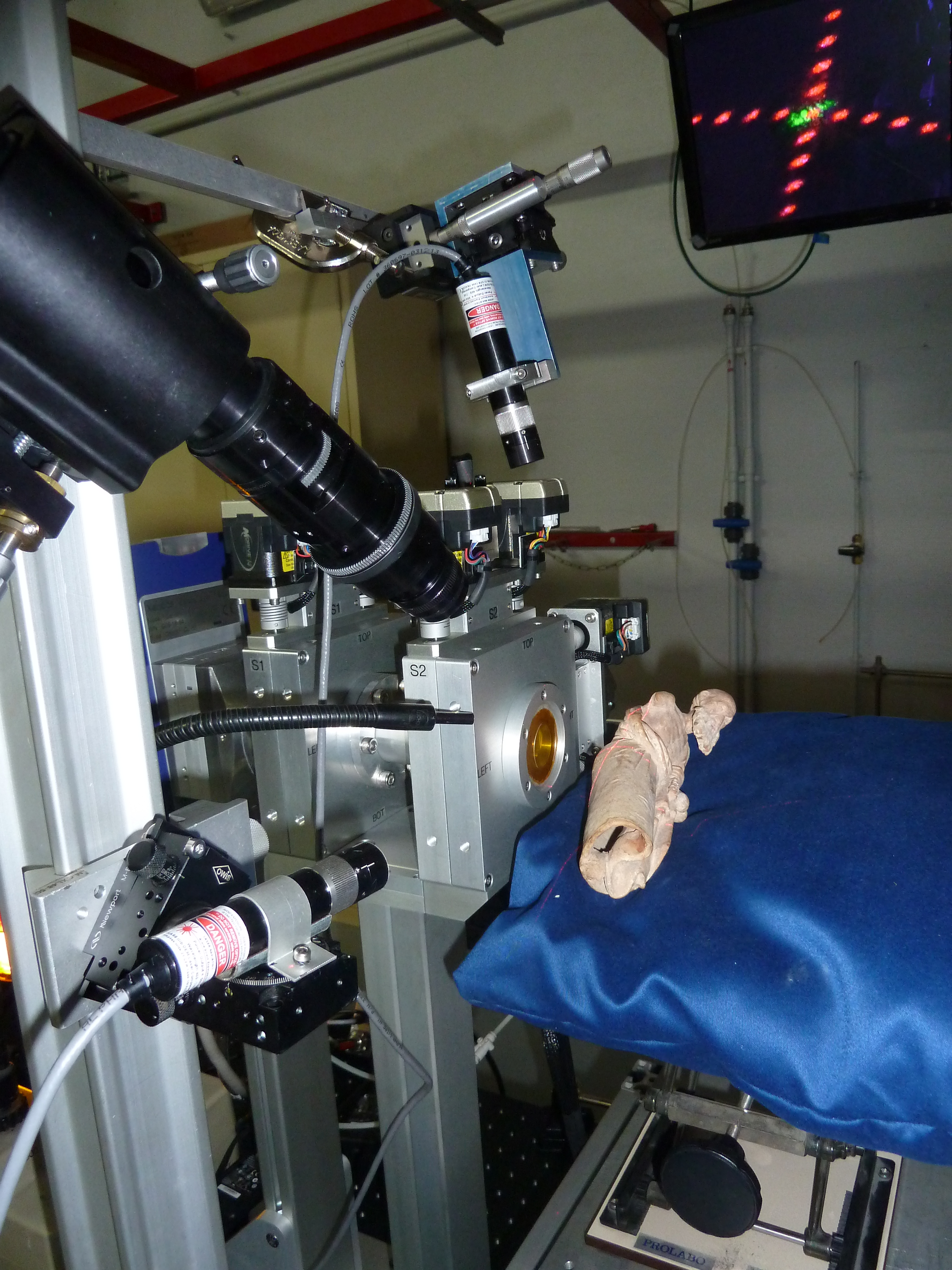 Photographie d’une figurine en terre cuite positionnée devant l’équipement de µ-diffraction des rayons X pour l’analyse de la couche picturale jaune de la tunique (©C2RMF, Yannick Vandenberghe)